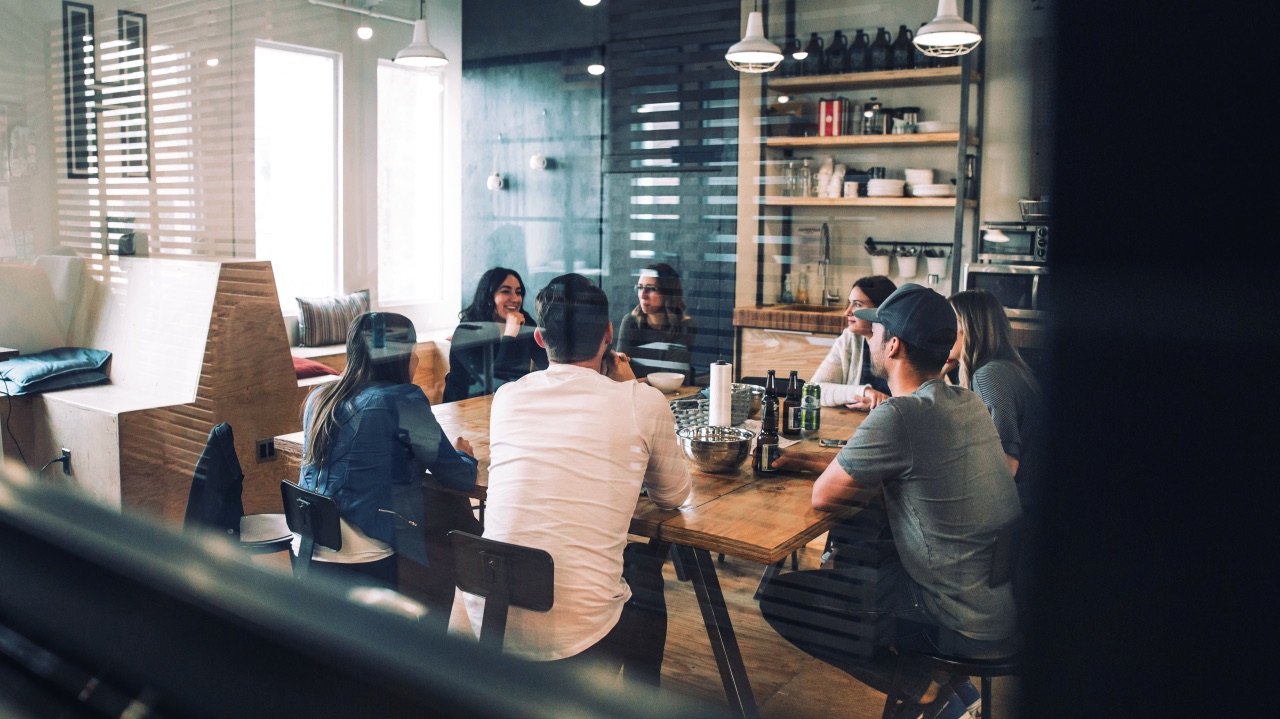 A group of colleagues in conversation around a table